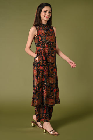 Black printed coord set with high closed neck and matching wide leg pants.
•	Floral prints all over the top.
•	High close neck with button, sleeveless, sleeves comes separately with the top.
•	Matching printed bottom wide leg pants with double sided elastic.
•	Chanderi rayon material.
