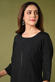 Plain black mirror worked straight cut set with zari woven dupatta and straight pants.
•	Plain top with mirror-work in neckline and back neck.
•	3/4 sleeves with mirror and thread work in border.
•	Single side elastic comfortable straight pants.
•	Matching black zari woven dupatta.
•	Chanderi material.
