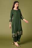 Solid green muslin kurti set with elephant print in border and sleeves.
•	Plain colour kurti with elephant prints in border and sleeve.
•	Round neck & 3/4 sleeves.
•	Double sided elastic and comfortable straight fit pants.
•	The green colour muslin with elephant prints will give a perfect occasional vibe.

